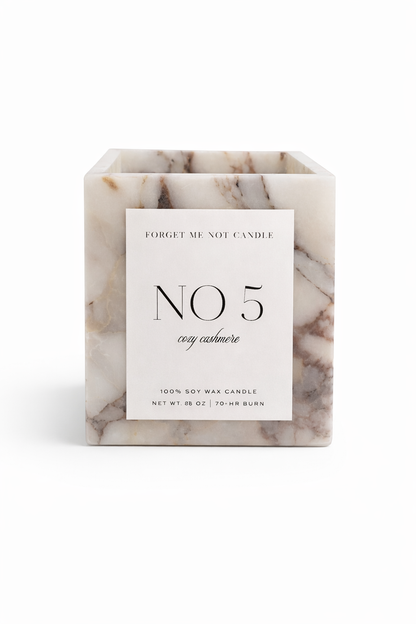 Marble-textured candle with a label on a white background